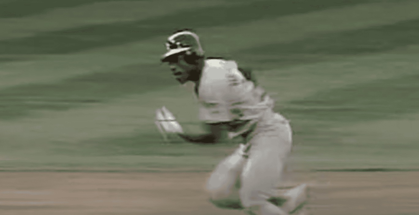 Image of Rickey Henderson stealing a base, showcasing his speed and impact on the game.